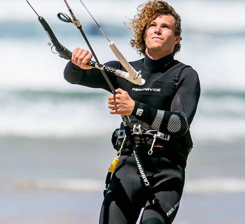 Student learning kite control on the beach